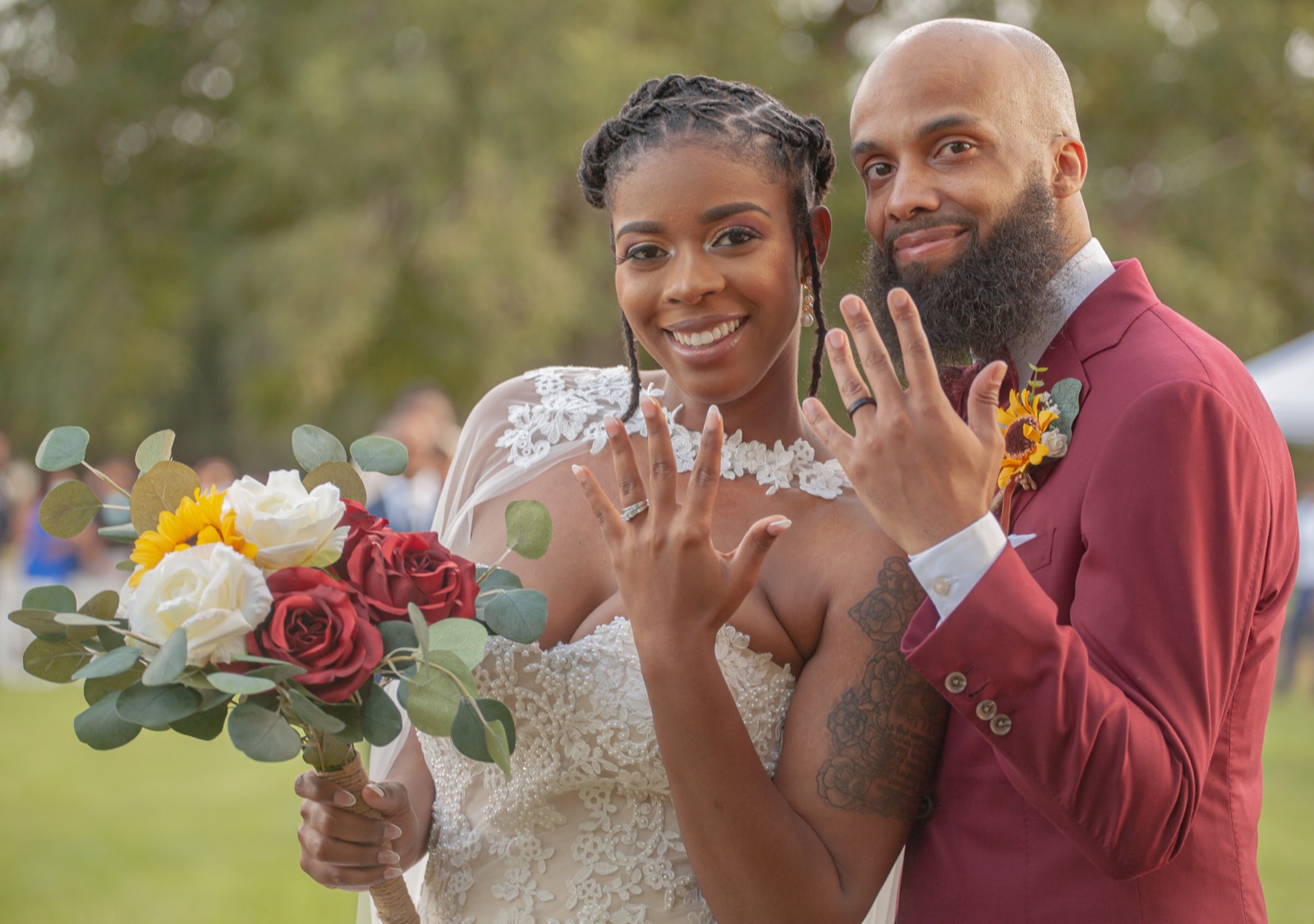 Newlyweds showing wedding rings with sunflower bouquet — Atlanta wedding photographer